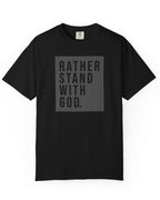 Flat lay of black Comfort Colors t-shirt with Rather Stand With God quote graphic on white background