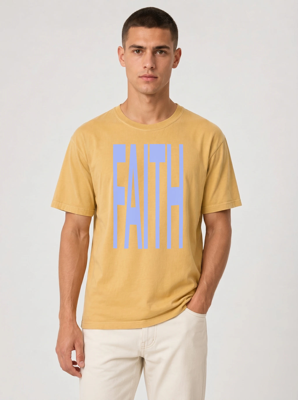 Person wearing a mustard yellow T-shirt with large light blue text reading “FAITH.”