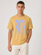 Person wearing a mustard yellow T-shirt with large light blue text reading “FAITH.”