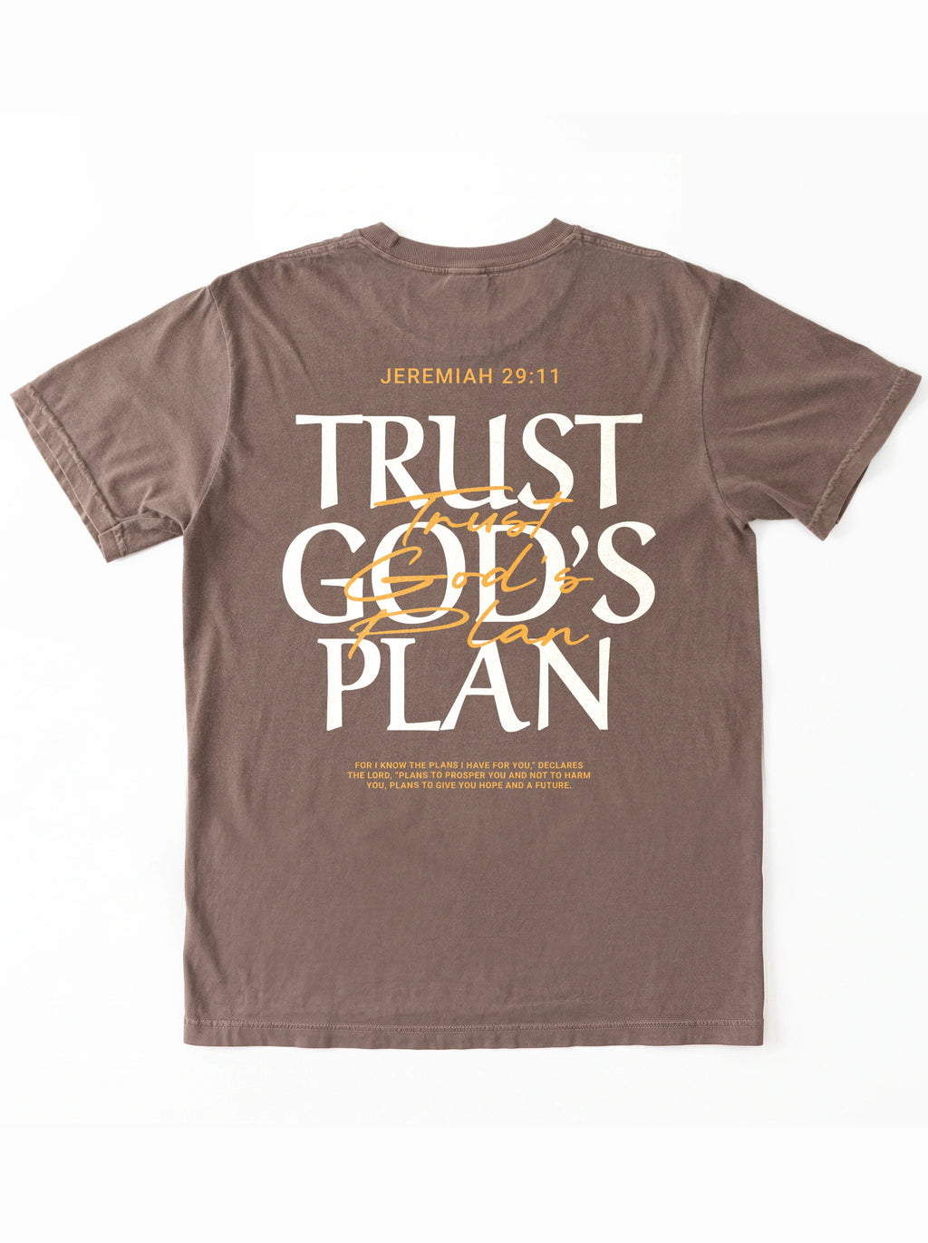 Faded brown T-shirt laid flat with a large back design reading “JEREMIAH 29:11” and “TRUST GOD’S PLAN,” with the verse below.
