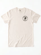 A cream-colored short-sleeve crewneck t-shirt with a circular black graphic on the left chest featuring a black circular graphic on that reads 'Salvation & Spirit Ephesians 6:17' around a helmet design.