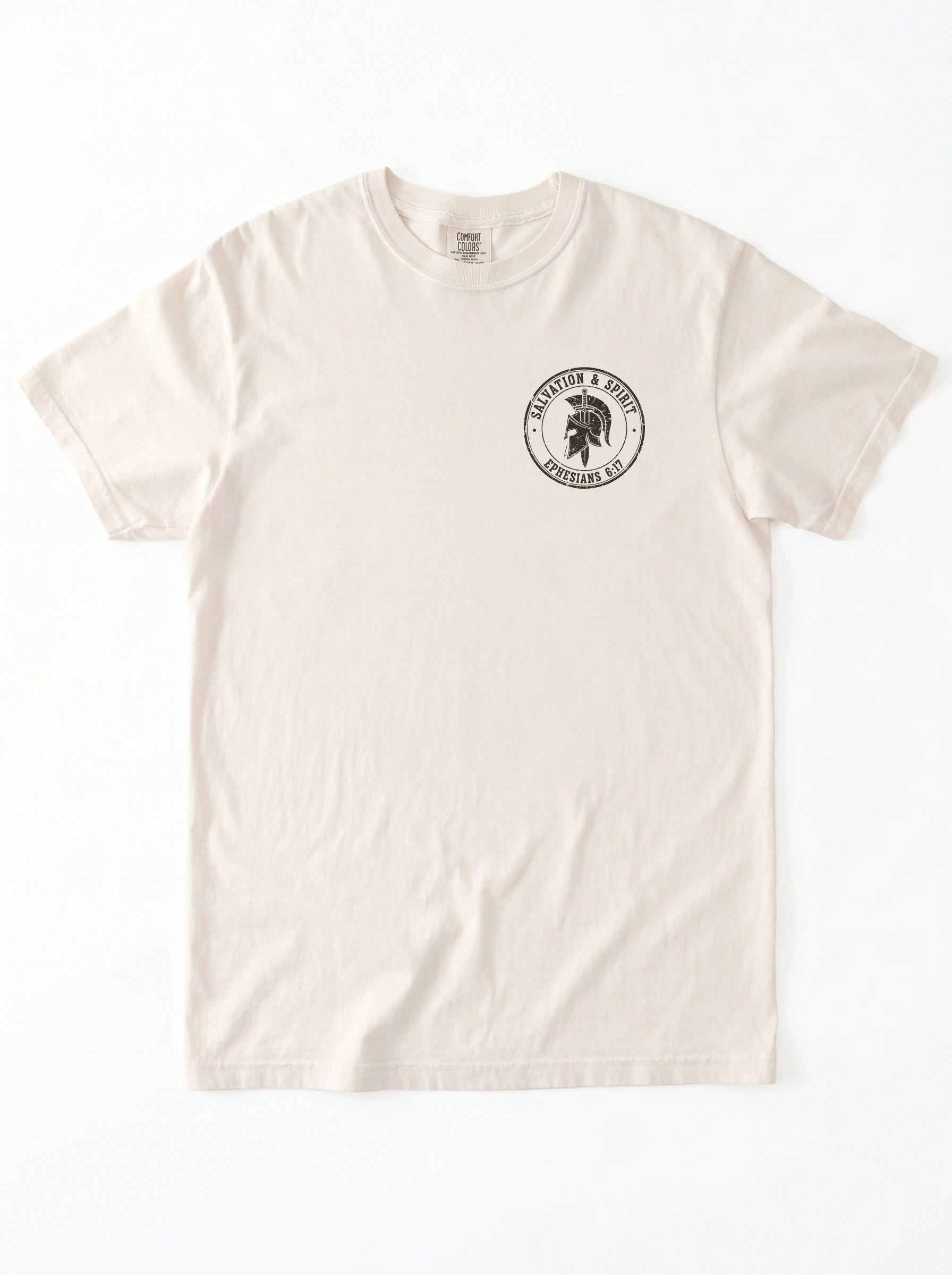 A cream-colored short-sleeve crewneck t-shirt with a circular black graphic on the left chest featuring a black circular graphic on that reads 'Salvation & Spirit Ephesians 6:17' around a helmet design.