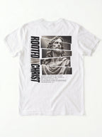 White T-shirt laid flat with a grayscale Jesus graphic, vertical “Rooted in Christ” text, and a Colossians 2:7 verse.