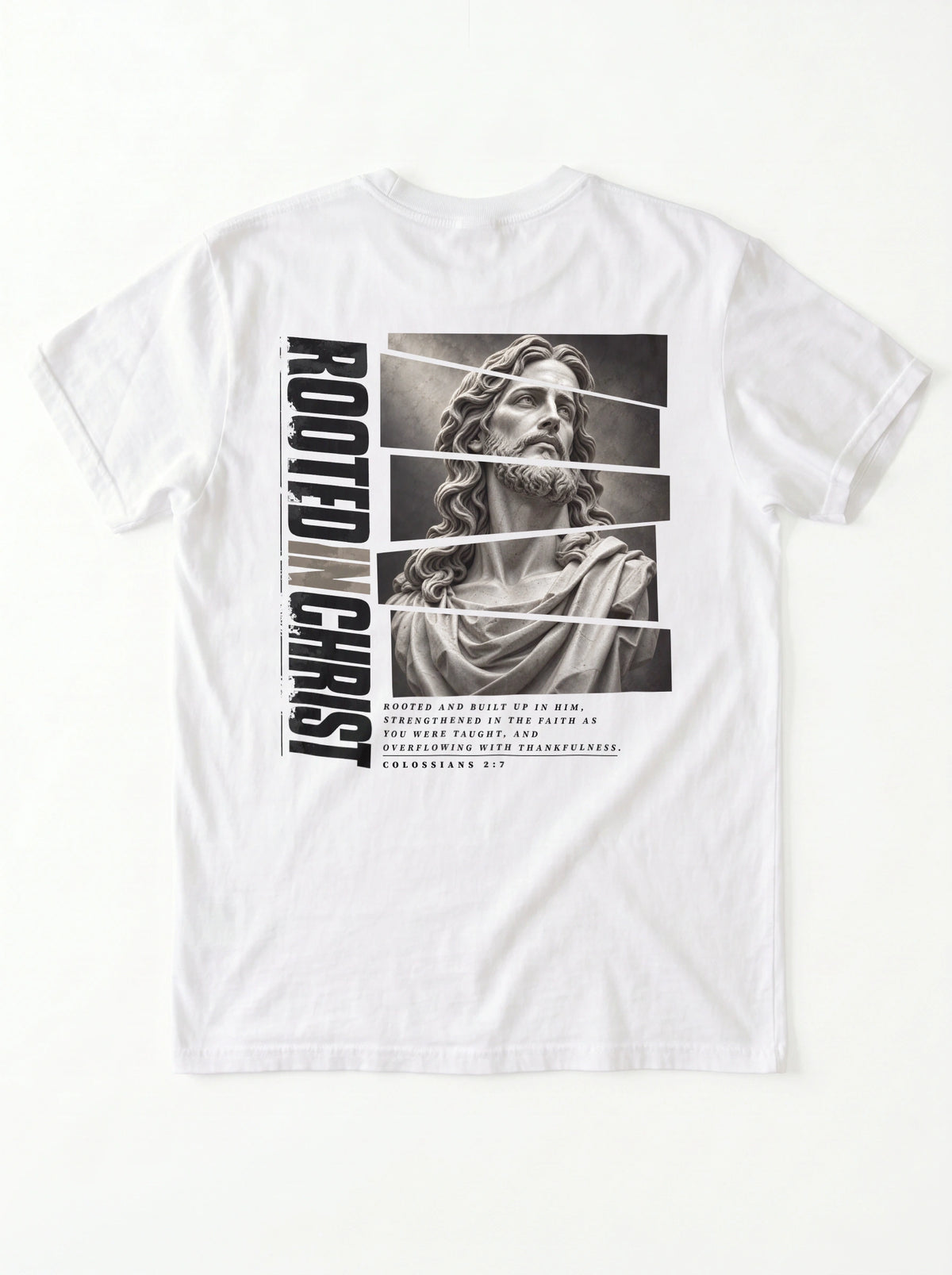 White T-shirt laid flat with a grayscale Jesus graphic, vertical “Rooted in Christ” text, and a Colossians 2:7 verse.