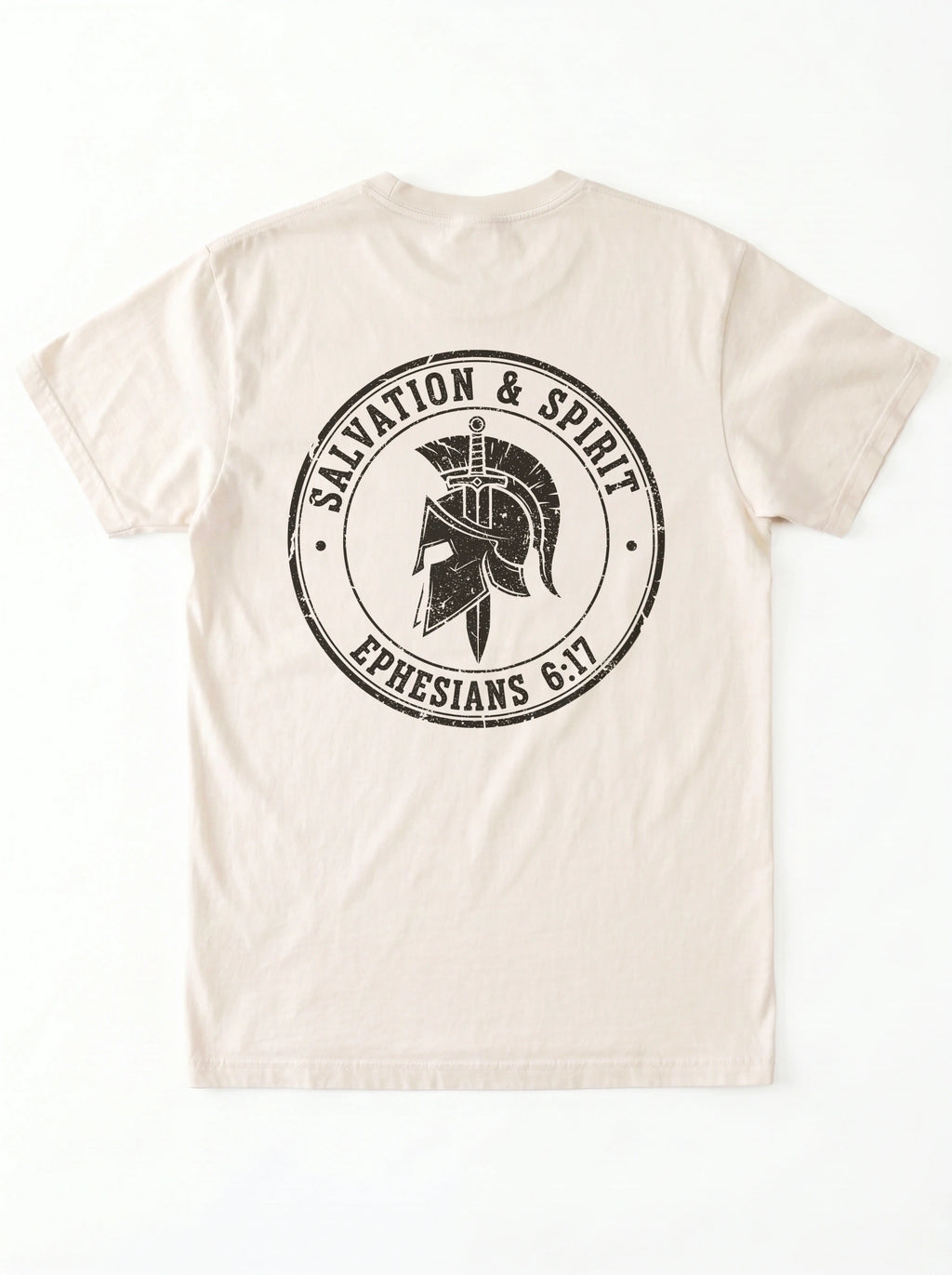 A light beige crewneck t-shirt shown from the back, featuring a large distressed black circular graphic with a Spartan helmet and the text 'SAVATION & SPIRIT' and 'EPHESIANS 6:17'.