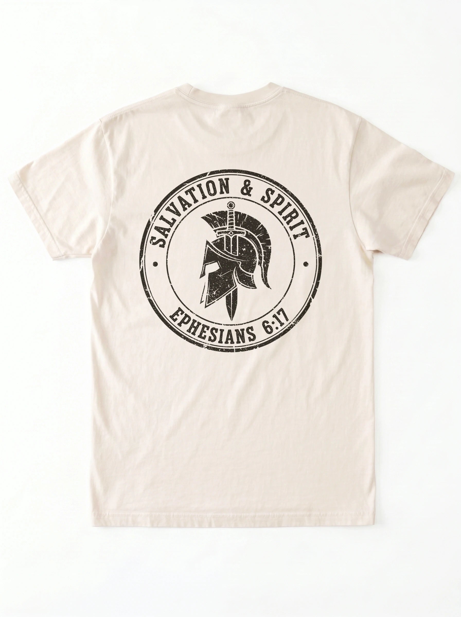 A light beige crewneck t-shirt shown from the back, featuring a large distressed black circular graphic with a Spartan helmet and the text 'SAVATION & SPIRIT' and 'EPHESIANS 6:17'.