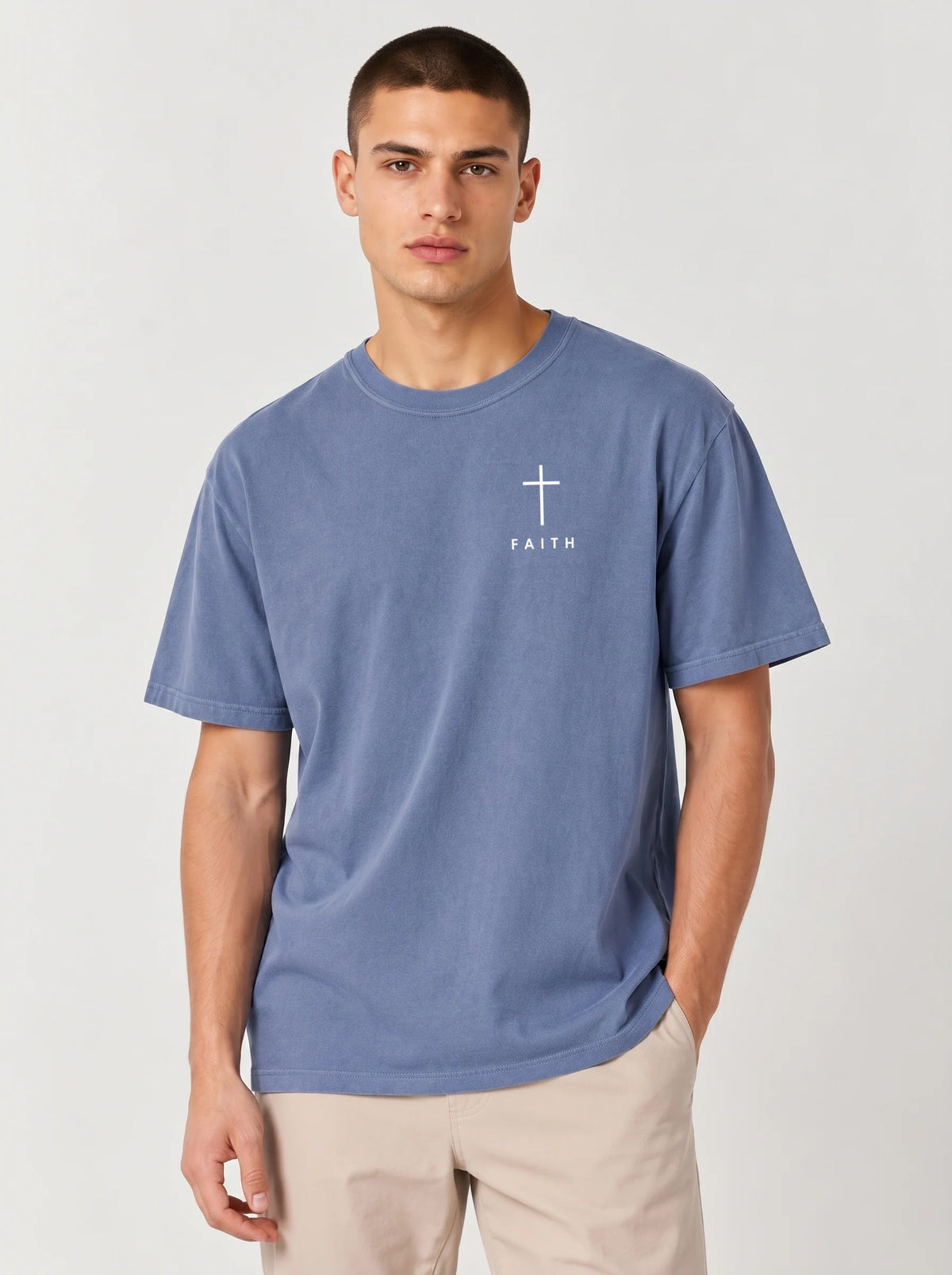Faded blue T-shirt laid flat with a white cross and “FAITH” printed on the chest.