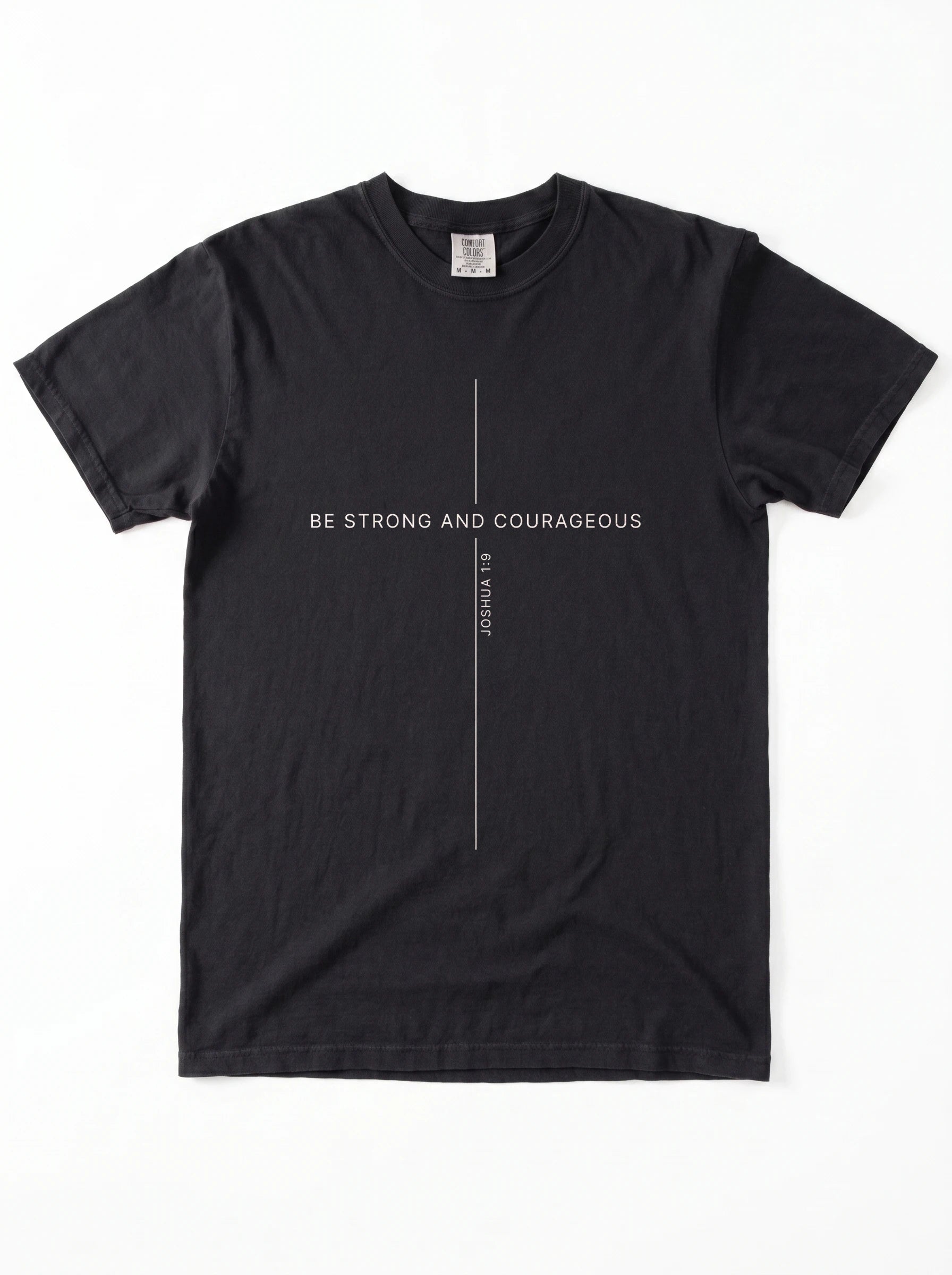A black short-sleeve crewneck t-shirt with a minimalist white graphic on the chest featuring a vertical line and the text 'BE STRONG AND COURAGEOUS' and 'Joshua 1:9'