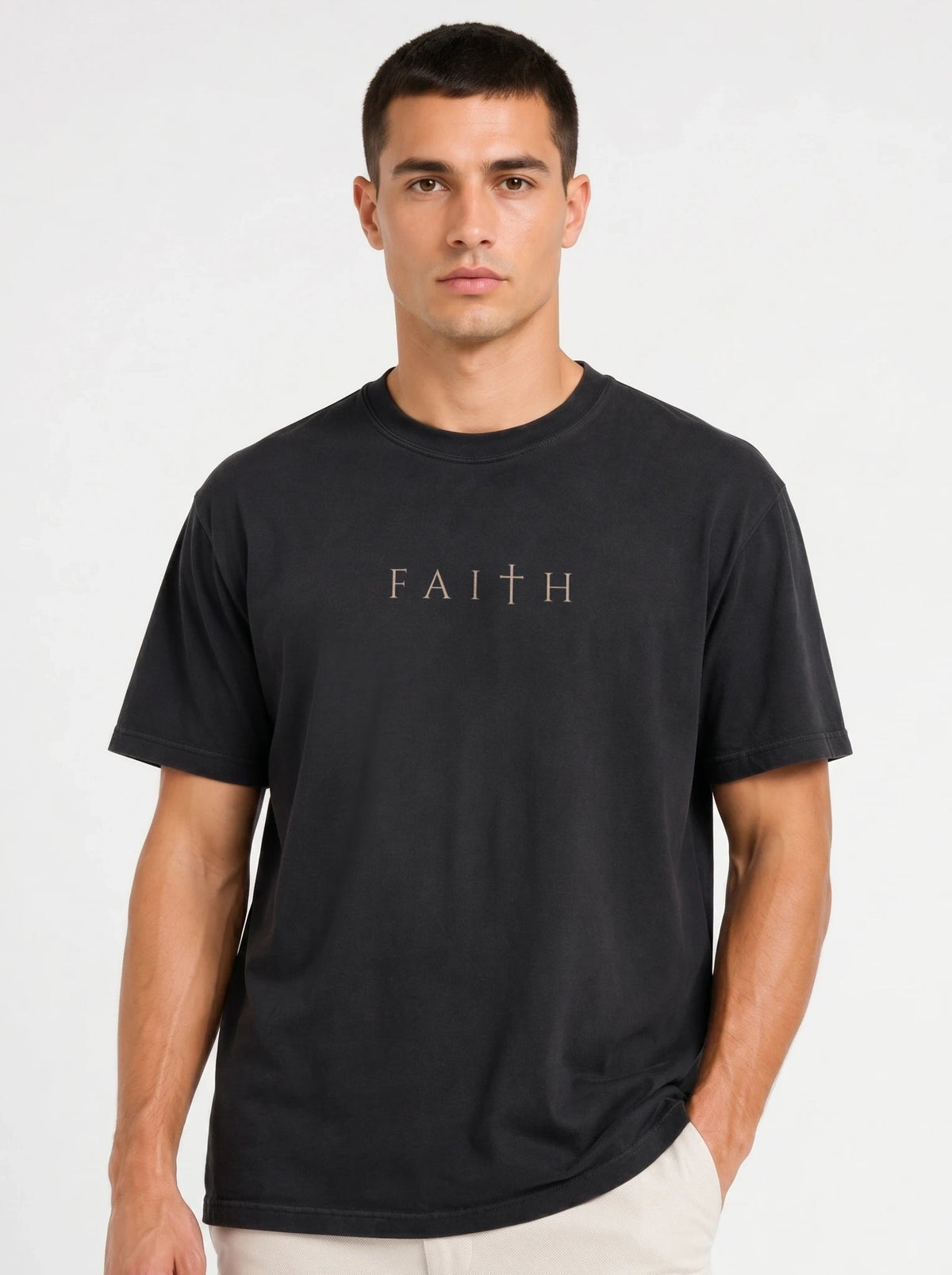 Close-up of man wearing dark gray garment-dyed Comfort Colors tee with minimalist Faith cross print