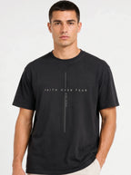 Person wearing a black T-shirt with a minimalist cross design and the text “Faith Over Fear” and “Psalm 118:6.”