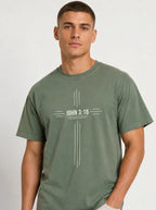 Person wearing a muted green T-shirt with a white cross-shaped design reading “John 3:16” and “For God so loved the world that he gave his one and only son.”
