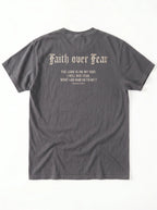 A dark gray t-shirt shown from the back, featuring a distressed cream-colored text graphic that reads 'Faith over Fear' followed by a Bible verse from Psalms 118:6.