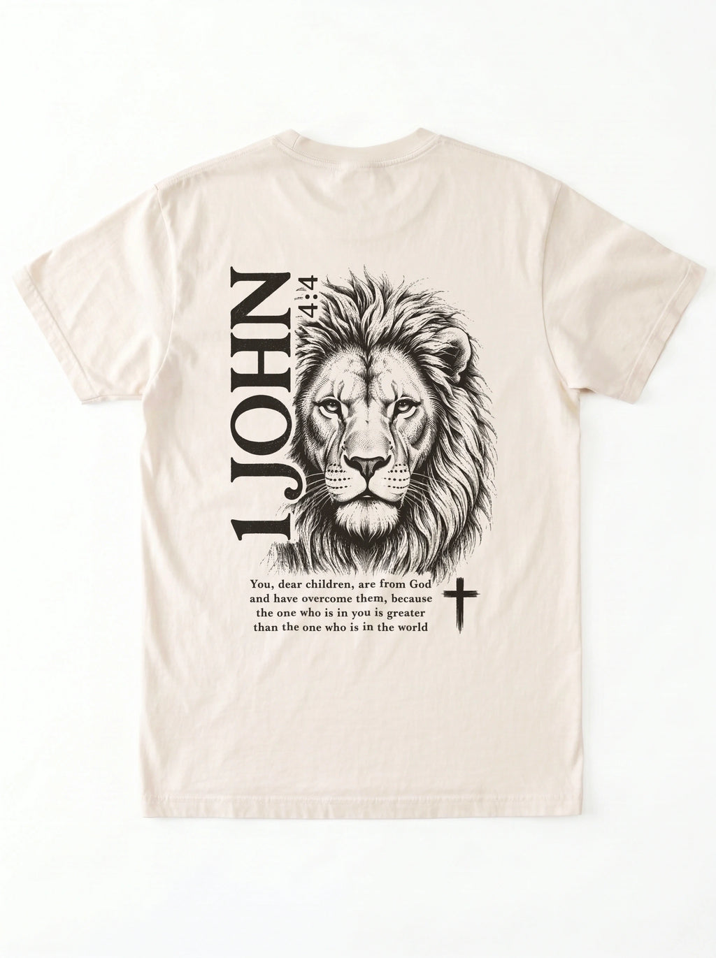 Cream T-shirt laid flat with black “1 John 4:4” text and a cross printed on the chest.