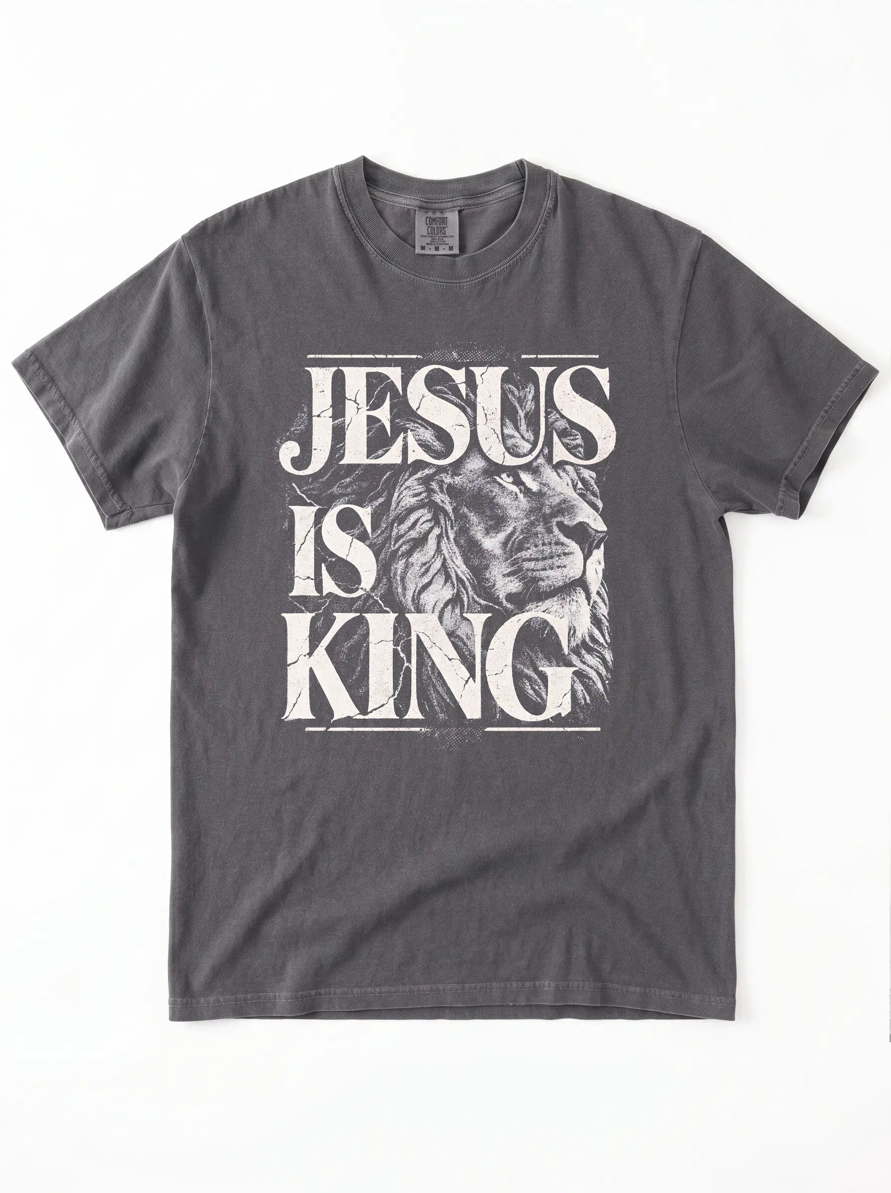 A dark gray crewneck t-shirt featuring a distressed white graphic print that reads 'JESUS IS KING' with a lion illustration, laid flat against a white background.