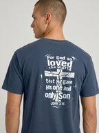 A man wearing a navy blue t-shirt, viewed from the back. The shirt features a large white graphic print with a cross and the biblical quote 'For God so loved the world that He gave His one and only Son JOHN 3:16'.