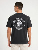 A man viewed from the back wearing a faded black t-shirt with a large white circular graphic on the back featuring a Spartan helmet and the text 'SALVATION & SPIRIT' and 'EPHESIANS 6:17'.
