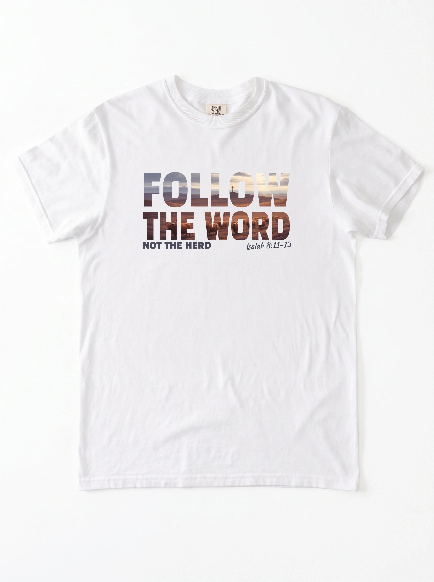A white short-sleeve crewneck t-shirt with a graphic print on the chest reading 'FOLLOW THE WORD NOT THE HERD' and 'Isaiah 8:11-13' in a textured, multi-toned font.