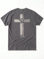 A dark gray crewneck t-shirt shown from the back, featuring a distressed biege graphic of a cross with the text 'I CAN DO ALL THINGS THROUGH CHRIST WHO STRENGTHENS ME' from Philippians 4:13.