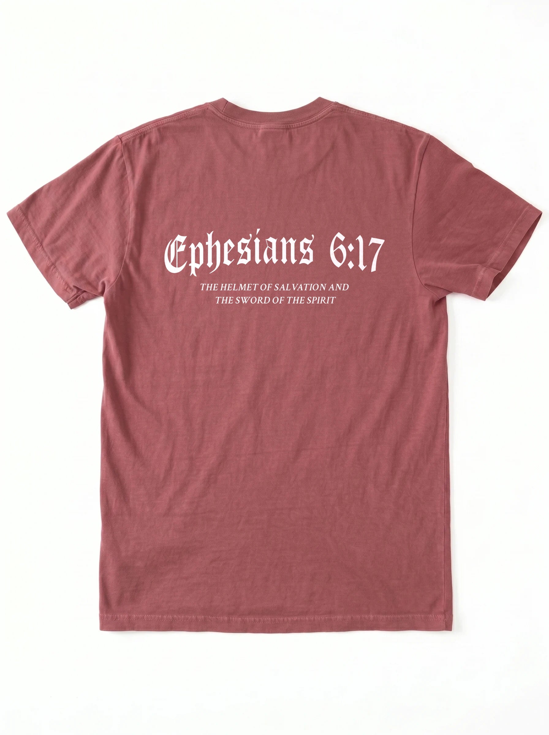 A dusty rose short-sleeve t-shirt shown from the back, featuring the text 'Ephesians 6:17' in a white Gothic font, with smaller white text underneath reading 'THE HELMET OF SALVATION AND THE SWORD OF THE SPIRIT'. The shirt is laid flat against a clean white background.