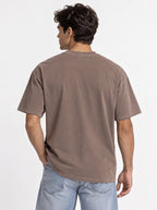 Person shown from behind wearing a plain faded brown T-shirt with no back print.