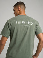 A man viewed from behind wearing an olive green t-shirt with 'Isaiah 41:10' printed in white gothic font across the upper back.