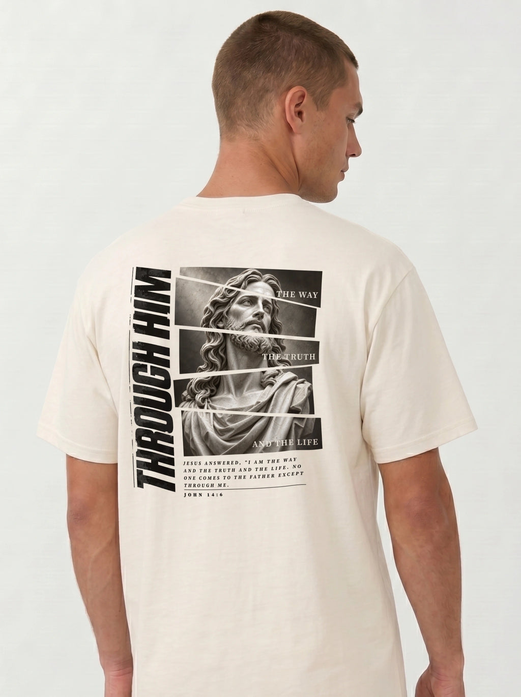 Person turned slightly sideways wearing a cream T-shirt with a grayscale Jesus graphic, “Through Him,” “The Way, The Truth, And The Life,” and John 14:6 text.