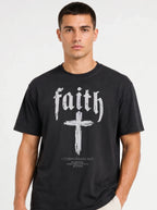 Person wearing a black T-shirt reading “faith” above a cross and “1 Corinthians 16:13 — Be watchful. Stand firm in the faith. Be strong.”