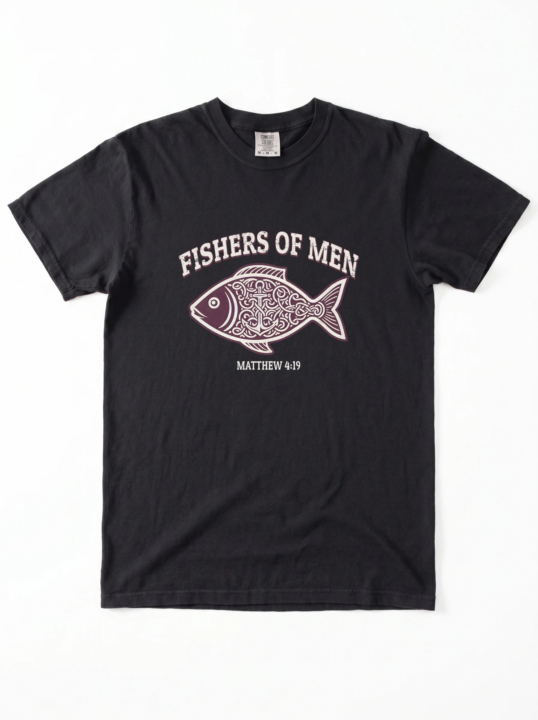 A black short-sleeve crewneck t-shirt featuring a graphic print of a patterned fish with the text 'FISHERS OF MEN' and 'MATTHEW 4:19' printed in white and light pink.
