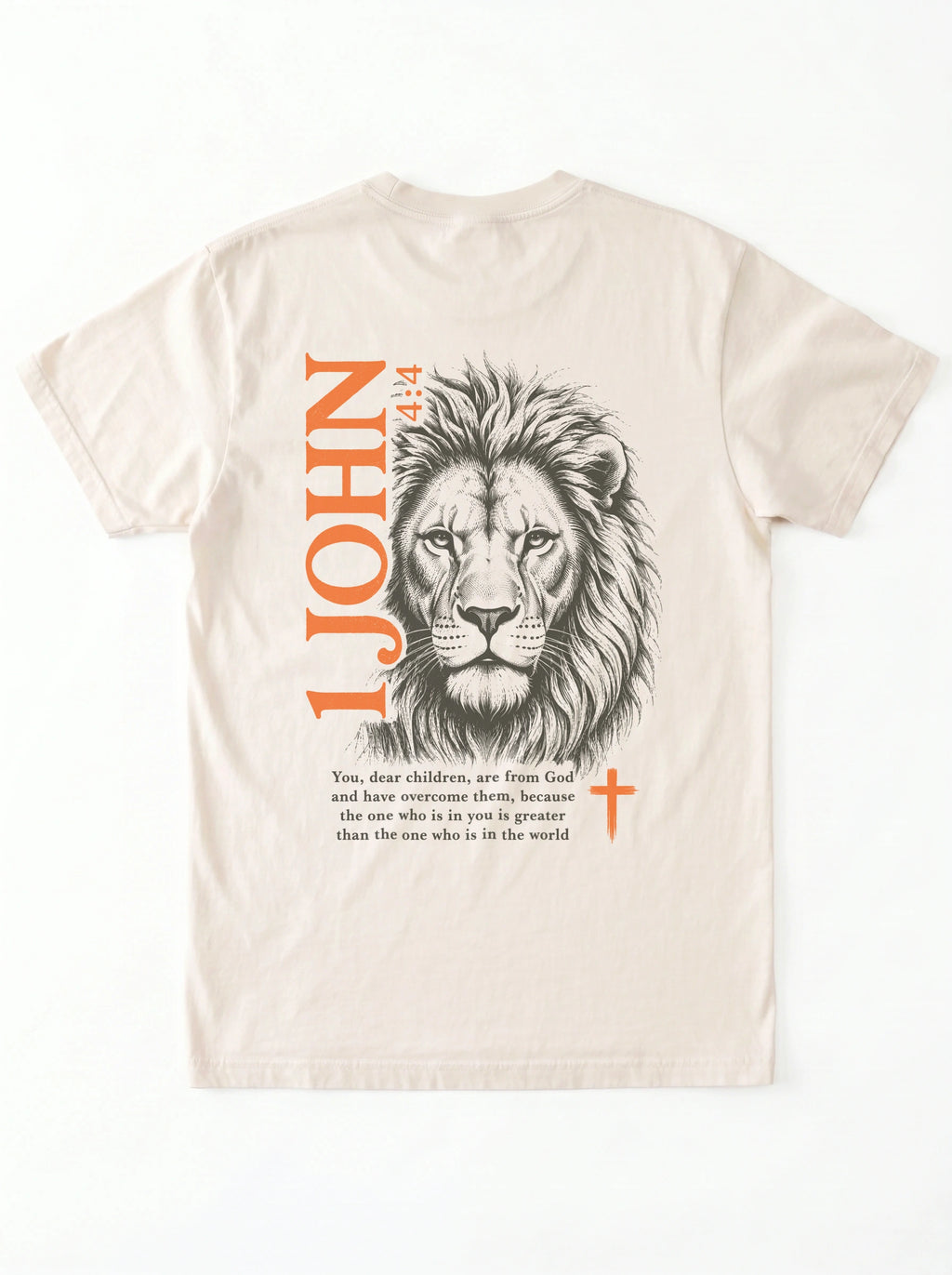 Back of a cream T-shirt with a lion illustration, orange “1 John 4:4” and cross, and the verse “You, dear children, are from God and have overcome them, because the one who is in you is greater than the one who is in the world.”