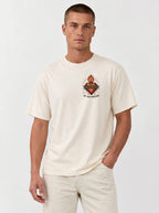 Cream T-shirt with a flaming sacred heart wrapped in a crown of thorns and the text “By His Wounds.”