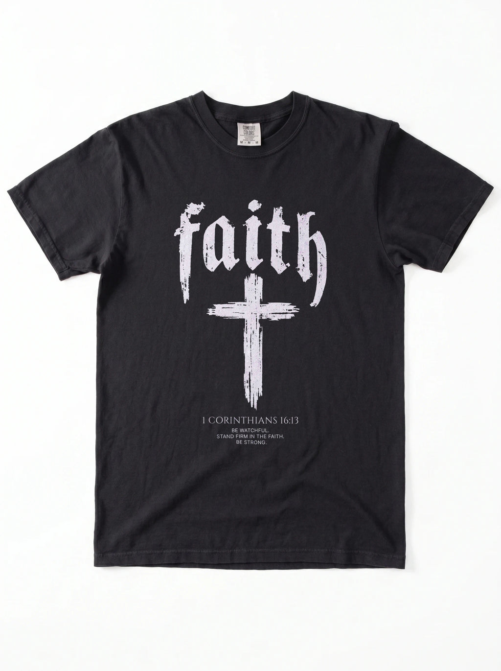 Black T-shirt laid flat with “faith,” a large cross, and “1 Corinthians 16:13 — Be watchful. Stand firm in the faith. Be strong.”