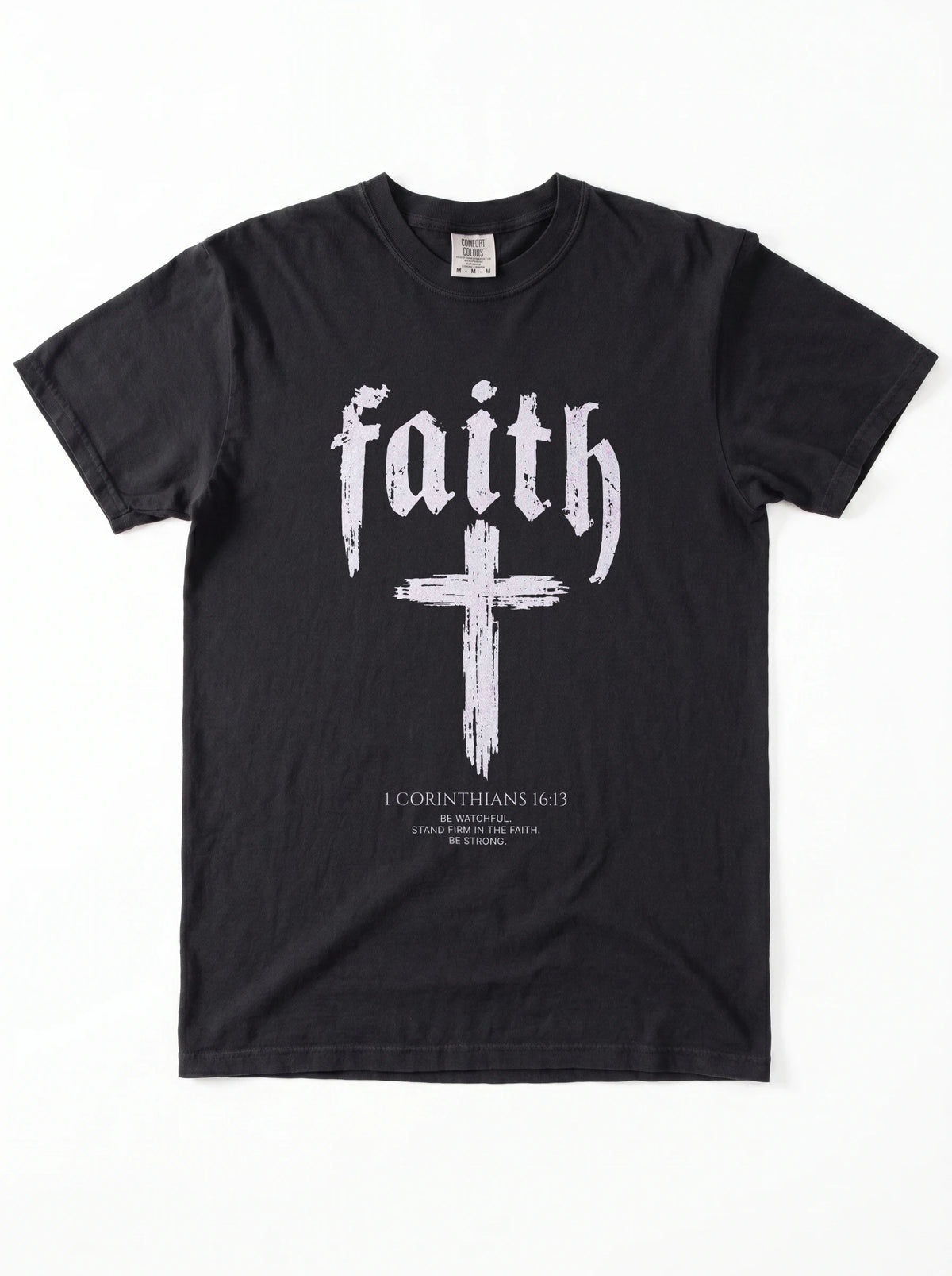 Black T-shirt laid flat with “faith,” a large cross, and “1 Corinthians 16:13 — Be watchful. Stand firm in the faith. Be strong.”