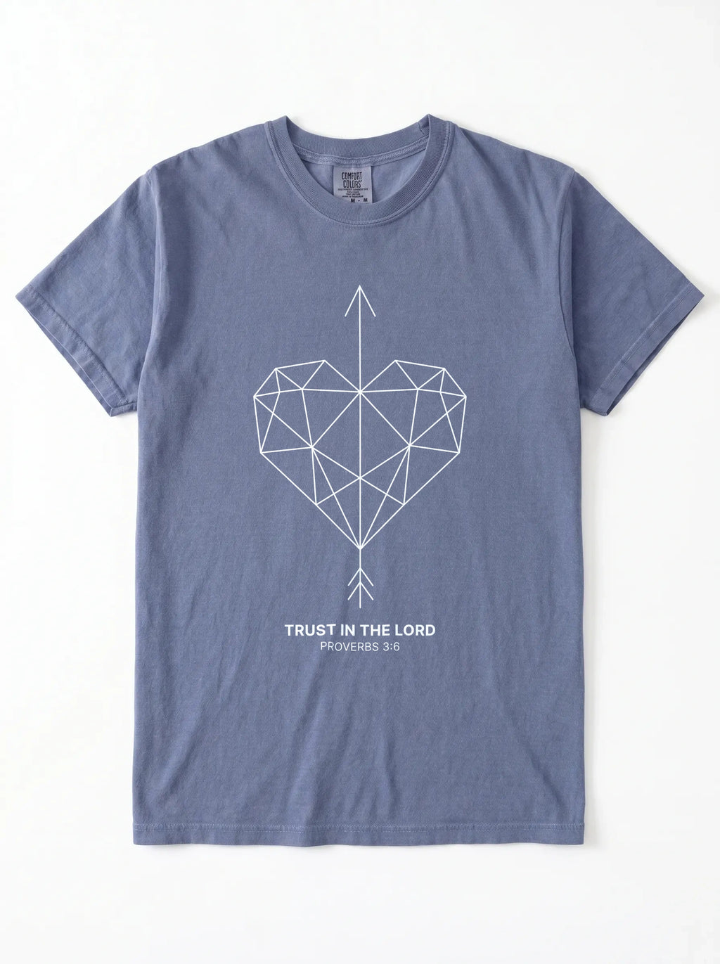 A slate blue crewneck t-shirt with a geometric heart pierced by an upward-pointing arrow, paired with the verse Proverbs 3:6: "Trust in the Lord." printed on the chest, displayed flat against a white background.