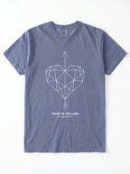 A slate blue crewneck t-shirt with a geometric heart pierced by an upward-pointing arrow, paired with the verse Proverbs 3:6: "Trust in the Lord." printed on the chest, displayed flat against a white background.