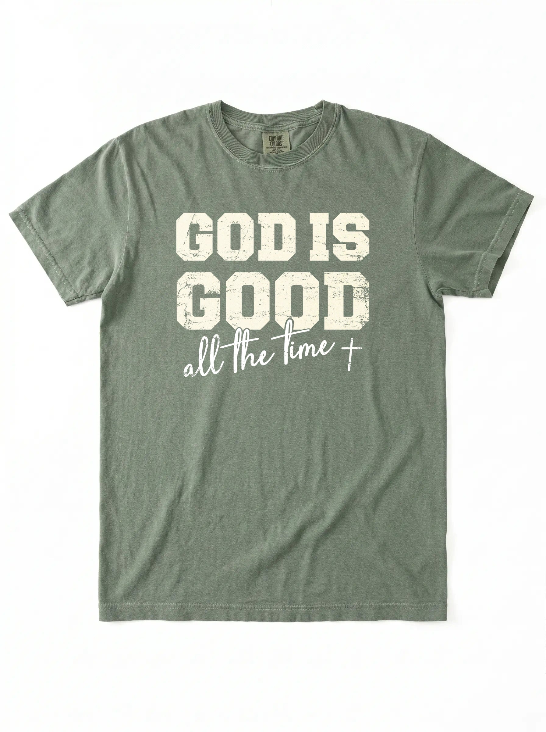 An olive green short-sleeve t-shirt with a distressed white graphic print on the front that reads 'GOD IS GOOD all the time +'.