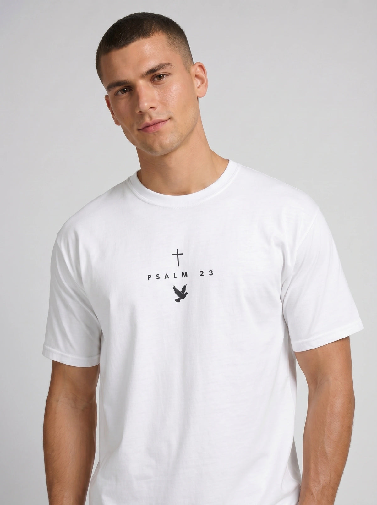 Person wearing a white T-shirt with a black cross, “PSALM 23” text, and dove graphic.