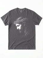 A dark gray crewneck t-shirt featuring a black and white graphic print of Jesus Christ wearing a crown of thorns, shown flat against a white background.