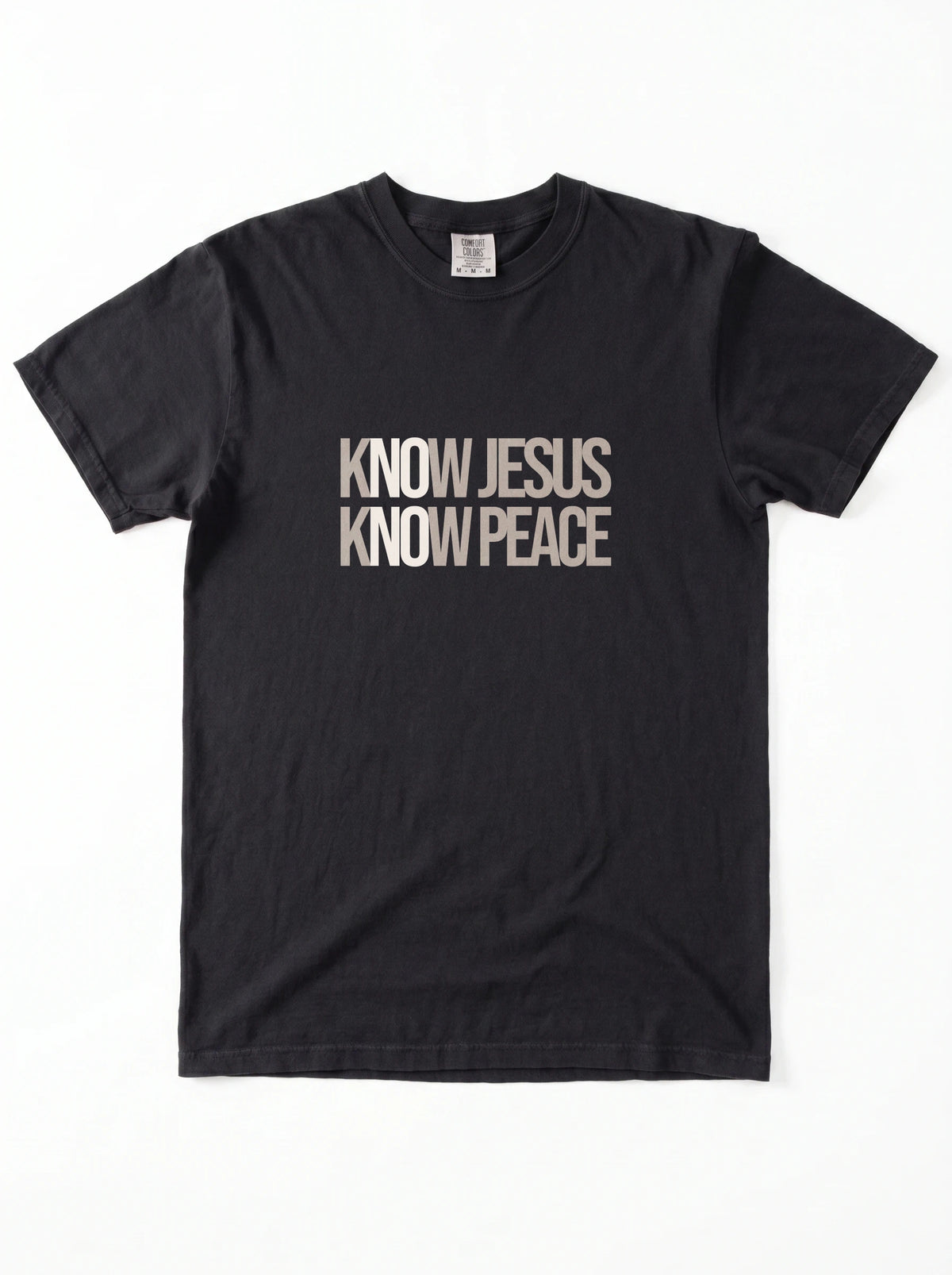 A black short-sleeve crewneck t-shirt with the text 'KNOW JESUS KNOW PEACE' printed in a distressed beige font across the chest, displayed flat against a white background.
