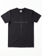 Flat lay view of a black short-sleeve t-shirt on a white background, featuring a white cross graphic, the text "IRON SHARPENS IRON", and the scripture reference "PROVERBS 27:17".