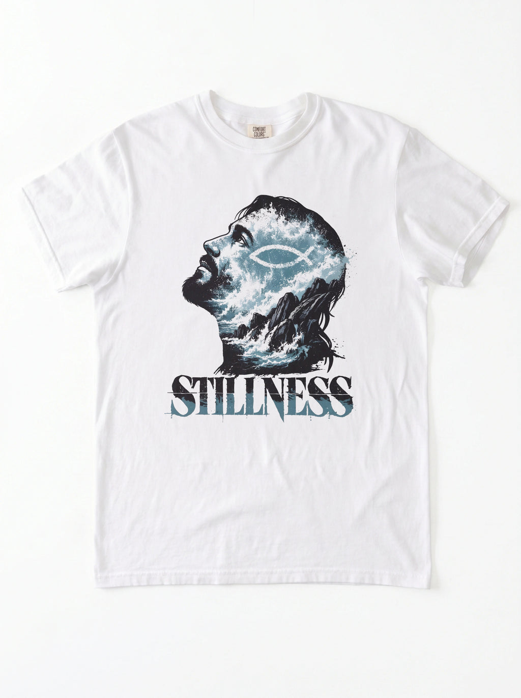 A white short-sleeve crewneck t-shirt featuring a graphic print of a man's profile filled with blue and white waves, with the word 'STILLNESS' printed below in a distressed blue font.