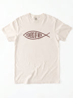 An off-white crewneck t-shirt featuring a dark brown graphic of a fish containing the text 'FISHERS OF MEN' on the chest, laid flat against a white background.