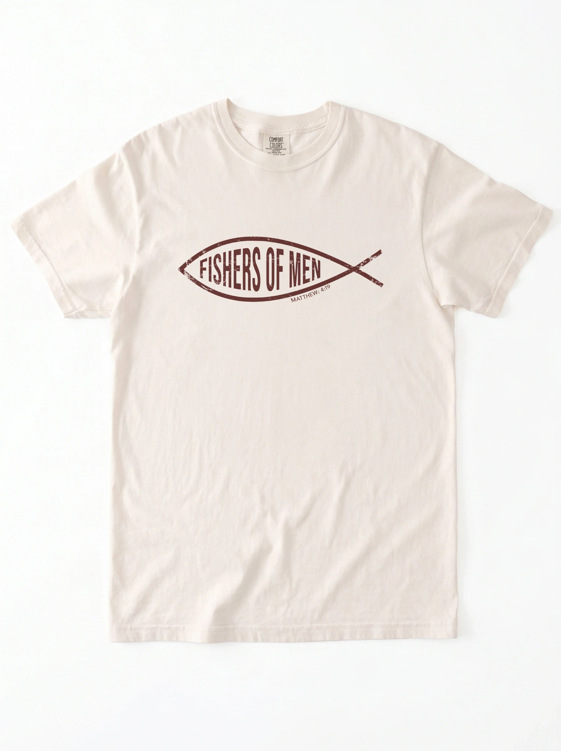 An off-white crewneck t-shirt featuring a dark brown graphic of a fish containing the text 'FISHERS OF MEN' on the chest, laid flat against a white background.