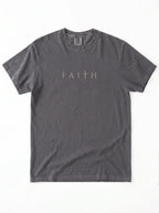 Flat lay of dark gray Comfort Colors 1717 t-shirt with Faith cross graphic print