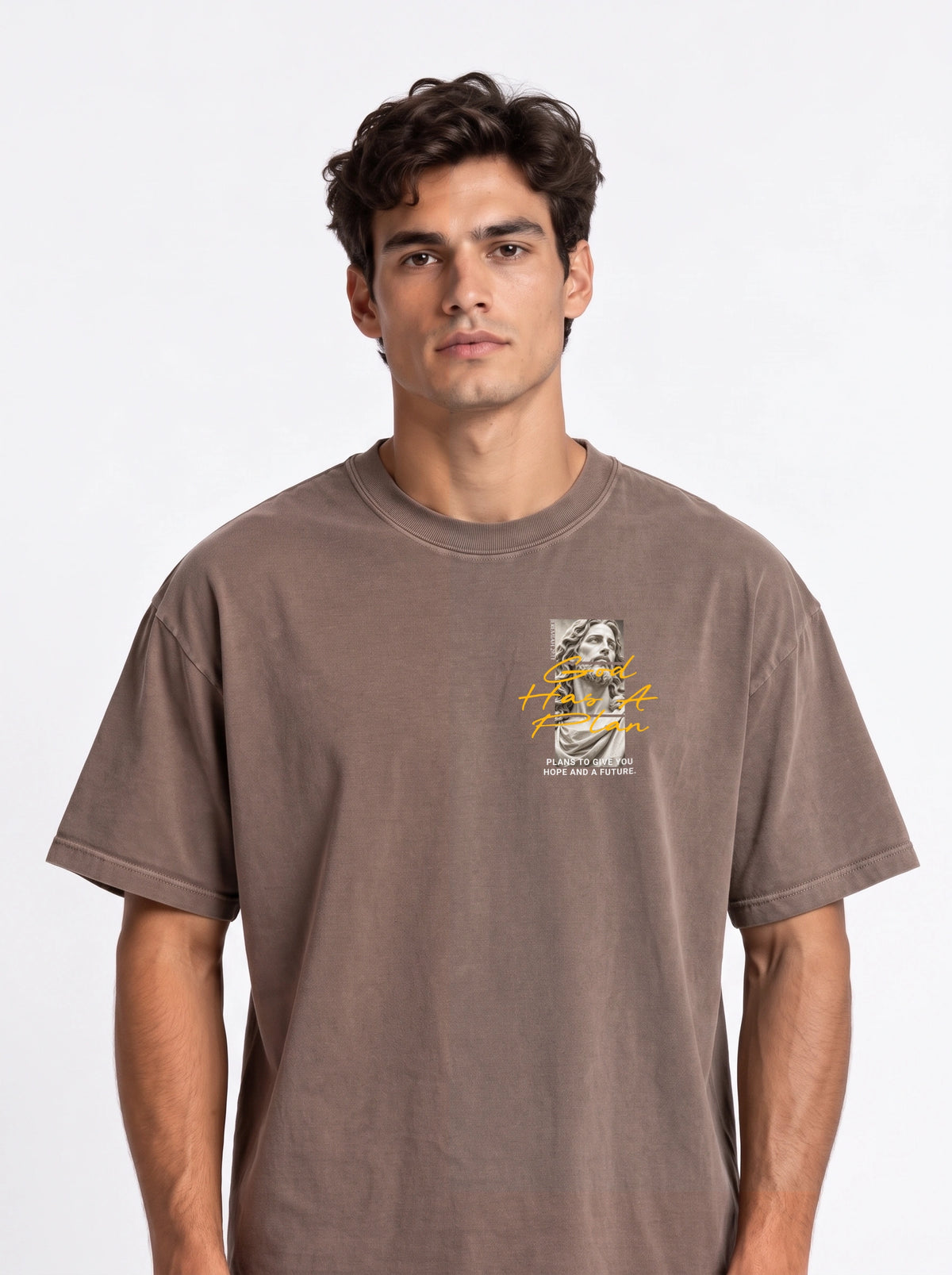 Person wearing a faded brown T-shirt with a statue graphic and the text “God Has A Plan” and “Plans to give you hope and a future.”