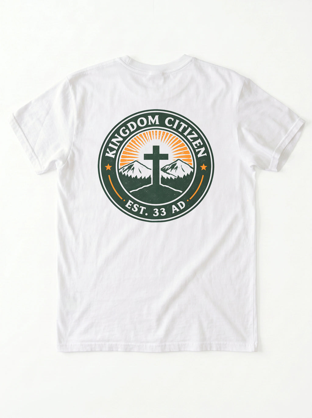 A white short-sleeve t-shirt laid flat against a white background, featuring a circular graphic on the chest with the text 'KINGDOM CITIZEN' and 'EST. 33 AD' surrounding a cross, mountains, and sunburst.