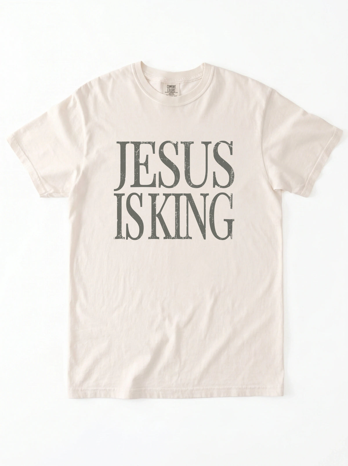 Flat lay of ivory Comfort Colors 1717 Jesus Is King graphic tee