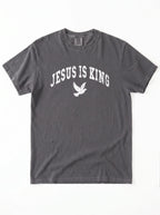Charcoal short-sleeve T-shirt laid flat, featuring distressed white “Jesus Is King” text and a flying dove graphic.