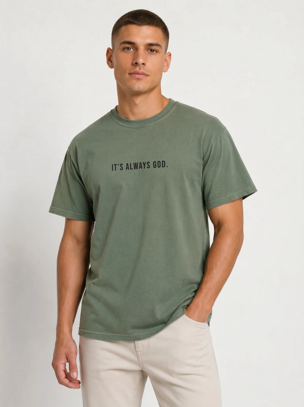 Person wearing a muted green T-shirt with the black text “It’s Always God.”