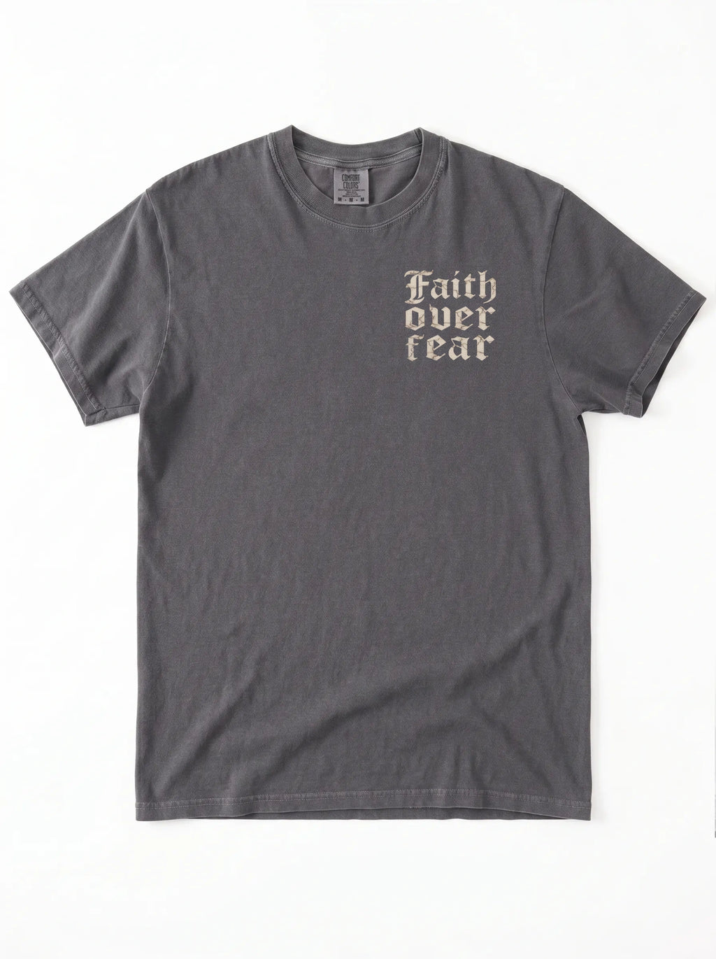 A dark gray crewneck t-shirt with the words 'Faith over fear' printed in a beige gothic font on the left chest, displayed flat against a white background.