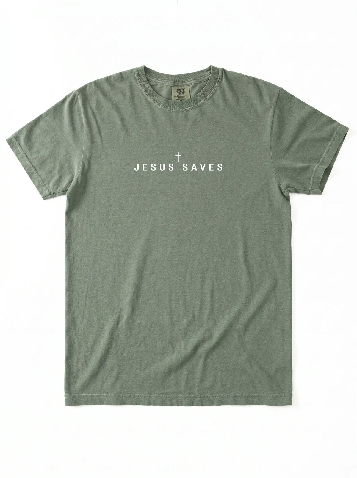 An olive green short-sleeve t-shirt with 'JESUS SAVES' and a small cross printed in white on the chest, laid flat against a white background.